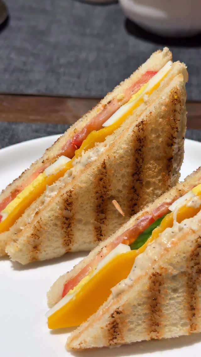 Pure Nostalgia in Every Bite – Pakistani Style Club Sandwich 🥪 
Make it for your next Iftar 🌙 

Chicken Filling
* 200 g boiled chicken, shredded
* 1 cup mayonnaise
* Salt to taste
* 1 tsp sugar
* 1 tsp black pepper
* Butter
* Bread slices 

In a bowl, combine the shredded chicken, mayonnaise, salt, sugar, and black pepper. Mix well until creamy and evenly combined. Spread butter on the bread slices and use the chicken mixture as the filling.

Eggs
* 2 boiled eggs, sliced (You can also use fried eggs instead if you prefer.)

Sauce
* 1/4 cup mayonnaise
* 1 tbsp ketchup
* 1/2 tbsp chili sauce 
* 1/2 tsp garlic powder
Mix everything together and set aside.

Vegetables & Cheese
* Thinly sliced cucumber
* Thinly sliced tomato
* Mozzarella cheese
* Cheddar cheese

To Assemble
* Toast both sides of the bread slices (use butter if desired)
1. Spread the prepared sauce on a slice of bread.
2. Spread the chicken filling, add second piece of toasted bread, top it with  cheese, sliced boiled eggs, cucumber, and tomato.
3. Top with the third slice of bread.
4. Trim the edges and cut into triangles.

Serve with fries, ketchup, or coleslaw. Enjoy ❤️

#itstastybygohar #clubsandwich #pakistanirecipes #homemadesandwich #sandwich

[Club Sandwich, Desi Food, Balery Style Club Sandwich, Pakistani Style Club Sandwich, creamy chicken sandwich]